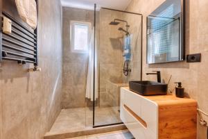 a bathroom with a shower and a sink at Old Town Apartments Brătianu - City Center Stay in Bucharest +14 photos