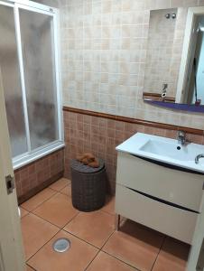 a bathroom with a sink and a mirror at Los Lentiscares Apartment in Torrox Costa