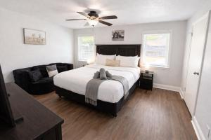 a bedroom with a large bed and a couch at Stylish Villa-Near Stadiums, Large Pool,Pool Table in Bedford +38 photos