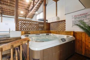 a jacuzzi tub in a room with wooden walls at The Summit at Mountainside in Stowe