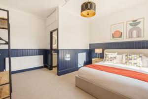 a bedroom with a large bed with blue and white walls at The Jam Jar, Newcastle, Jesmond in Jesmond +55 photos