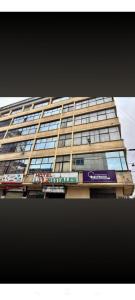 a tall building with a sign in front of it at Hotel Cristals Centro Bogota Estacion las Nieves Calle 18 numero 10 65 in Estación El Salto