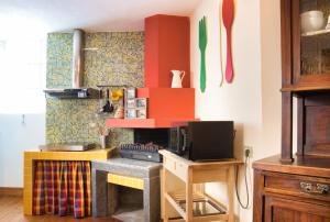 a kitchen with a counter with a stove top oven at Authentic Lake Como Home near Bellagio in Limonta