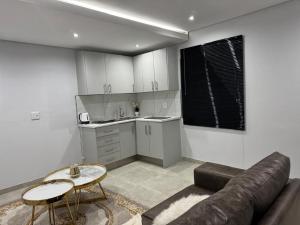a living room with a couch and a table at DECADE Self-catering in Swakopmund