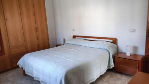 a bedroom with a bed and two night stands at Casa Nonno Maiti in Scardovari