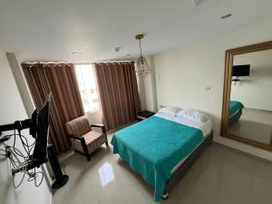 a bedroom with a bed and a television and a camera at Casa del Inka Perú in Lima +13 photos