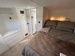 a small bedroom with a bed and a window at Unique 2 Bed Waterside Retreat Pet Friendly in Upton upon Severn