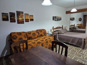 a living room with a couch and a table at Colorina Bariloche en edificio Bariloche Center in San Carlos de Bariloche