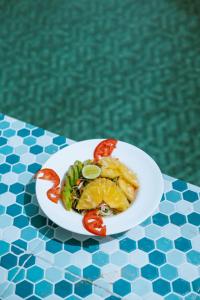 a plate of food on a table next to a pool at Farashuu Luna Hotel in Kendwa +43 photos