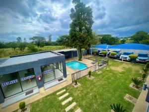 an aerial view of a building with a pool and parked cars at Bluenova guesthouse in Dundee