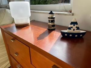 a wooden dresser with a lamp and a hat on it at Oaza Jeziorak in Siemiany +23 photos