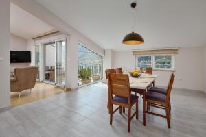a kitchen and dining room with a table and chairs at Libera Vista by MN Property in Kotor