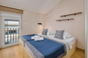 a large bed in a room with a large window at Libera Vista by MN Property in Kotor