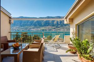 a patio with a table and chairs on a balcony at Libera Vista by MN Property in Kotor