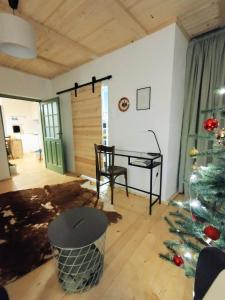 a living room with a christmas tree and a desk at Mera Small House in Mera +4 photos