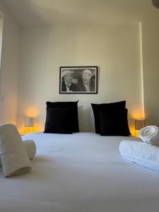 a bedroom with a large white bed with two men at La suite du parc 2 in Nancy