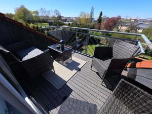 a deck with chairs and a table and a grill at Ferienwohnung Groß-Umstadt in Groß-Umstadt +4 photos