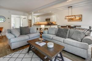 a living room with two couches and a table at Topnotch Retreat in Stowe Fork
