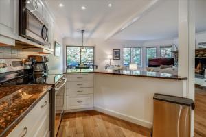 a kitchen with white cabinets and a counter top at Topnotch Retreat in Stowe Fork