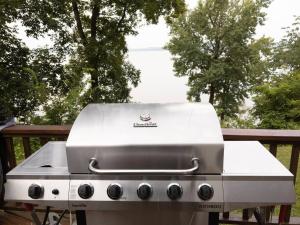 a grill sitting on a table with trees in the background at Hidden Shores in Big Sandy