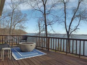 a tub on a deck with a view of the water at Hidden Shores in Big Sandy
