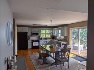 a kitchen and dining room with a table and chairs at Hidden Shores in Big Sandy