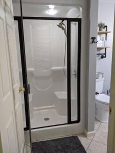a shower with a glass door in a bathroom at Hidden Shores in Big Sandy +15 photos