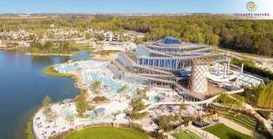 an aerial view of a resort with a water park at Le Refuge Douillet à 10min de Disneyland avec Parking Privé et Belle terrasse vue sur Jardin in Coupvray