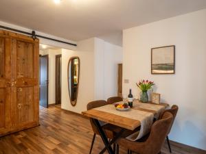 a dining room with a wooden table and chairs at Cjase san Pieri in Cividale del Friuli
