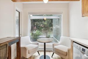 a kitchen with a table and two chairs and a window at Topnotch 329E in Stowe Fork +24 photos