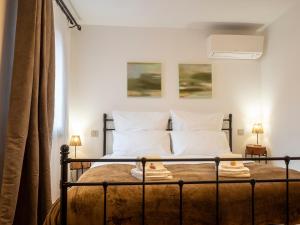 a bedroom with a bed with two white pillows at Cjase san Pieri in Cividale del Friuli