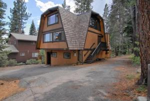 a tree house with a gambrel roof at Runnymeade Cottage in Kings Beach