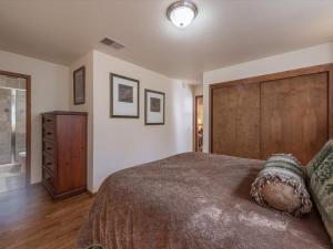 a bedroom with a large bed and a wooden headboard at Runnymeade Cottage in Kings Beach