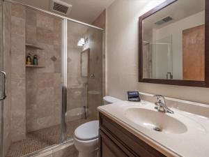 a bathroom with a toilet and a sink and a shower at Runnymeade Cottage in Kings Beach +23 photos