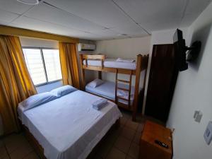 a small room with two beds and a bunk bed at Casa Aranza in Cartagena de Indias