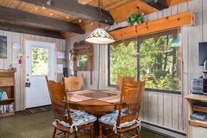 a dining room with a wooden table and chairs at Mirthwood Den in Tahoma