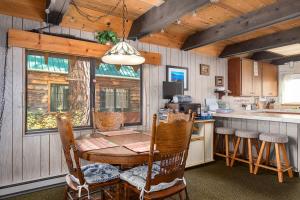 a kitchen with a table and chairs in a cabin at Mirthwood Den in Tahoma