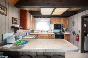 a kitchen with a table in the middle of it at Mirthwood Den in Tahoma
