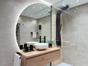 a bathroom with a sink and a mirror at ZELUN Suite Torremolinos Center in Torremolinos