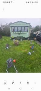 a picture of a yard with a green house at 68 Lochview in Stranraer