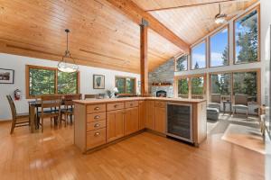 a kitchen and dining room with wooden ceilings and a dining table at The Wildwood Lodge in Tahoe Vista