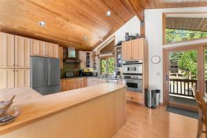 a large kitchen with wooden cabinets and a counter top at The Wildwood Lodge in Tahoe Vista +22 photos
