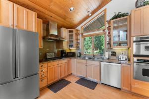 a kitchen with wooden cabinets and stainless steel appliances at The Wildwood Lodge in Tahoe Vista