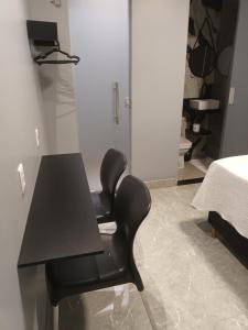 a black chair in a room with a table at 2367 Belém Residence in Belém +12 photos