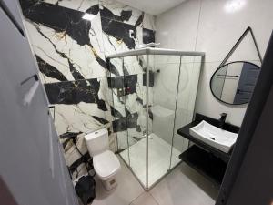 a bathroom with a shower and a toilet and a sink at 2367 Belém Residence in Belém