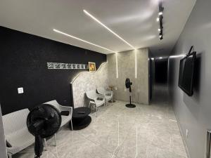a room with a room with chairs and a fan at 2367 Belém Residence in Belém