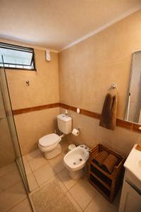 a bathroom with a toilet and a sink at Huaco Casa de Campo in Belén +34 photos