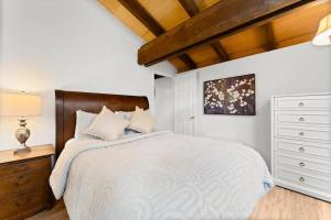 a bedroom with a large bed and a wooden ceiling at Dolly Varden Cottage in Kings Beach