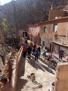a group of people walking down a street at Gite ousalem timichi in Timichchi +12 photos