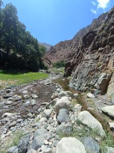 a river in the mountains with rocks and trees at Gite ousalem timichi in Timichchi